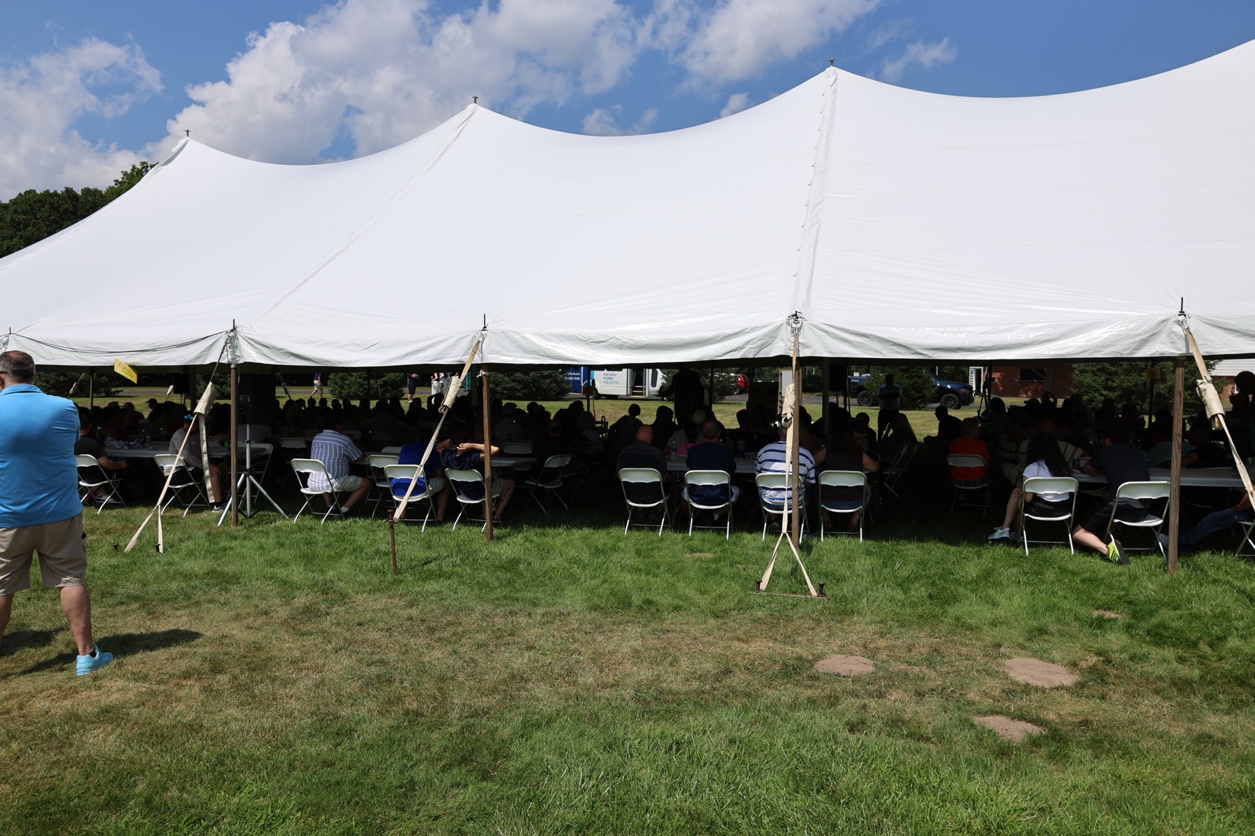 Guests gathered beneath the main tent to listen together